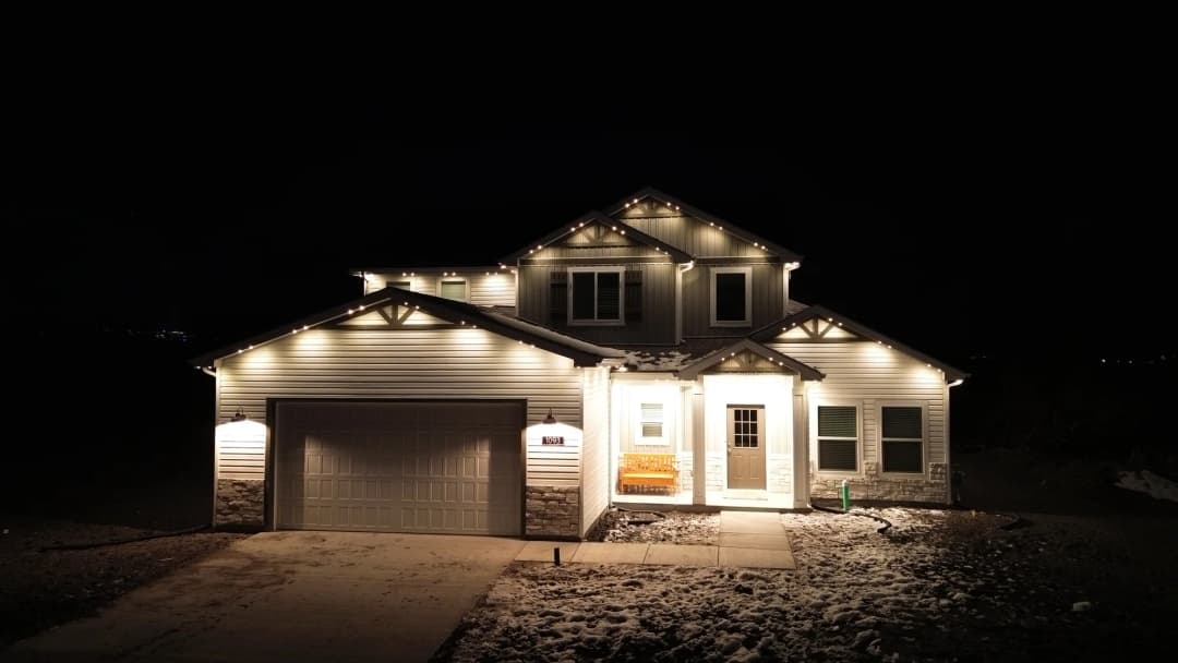 Warm white permanent lighting on a Utah home in winter